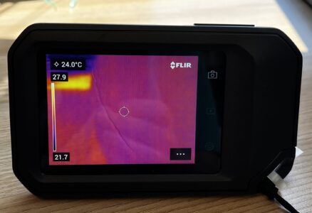 Image of a thermal camera showing a lit up screen of purples and orange detecting heat