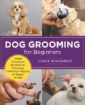 Dog Grooming for Beginners: simple techniques for washing, trimming, cleaning & clipping all breeds of dogs by Jorge Bendersky shows a small white and tan dog having his nails trimmed, being washed and fur being cut.